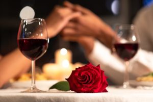 Romantic things to do in Bardstown KY, dining at a restaurant table with rose and red wine
